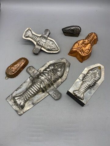 Six lobster-shaped tin or copper chocolate...