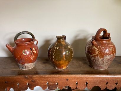 VAL DE SAONE. Three glazed earthenware jugs...