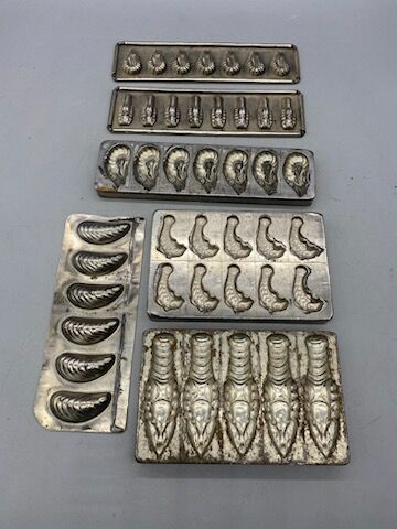 Eleven tinplate and metal chocolate mold...