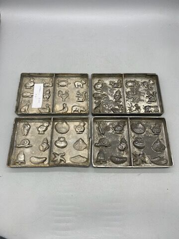 Four chocolate mold plates, metal, with motifs...