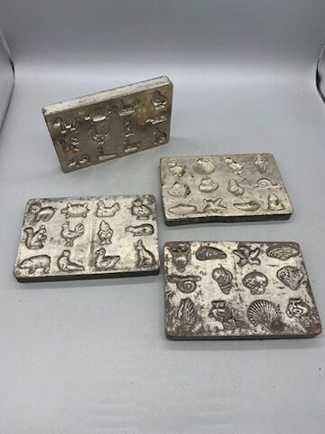 Four chocolate mold plates, metal, with motifs...