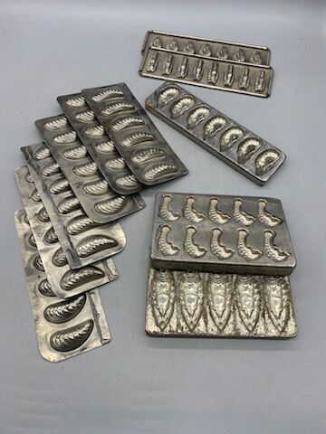 Eleven tinplate and metal chocolate mold...
