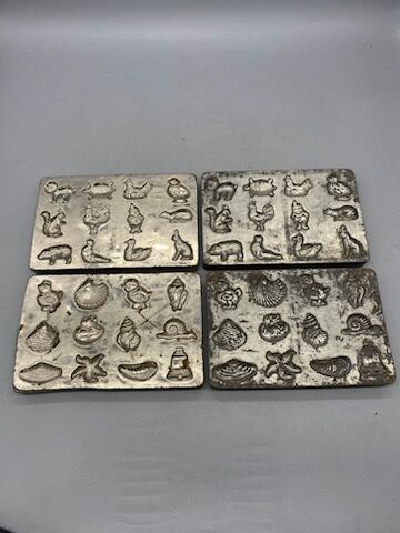 Four chocolate mold plates, metal, with motifs...