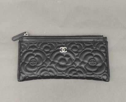CHANEL. Camellia-stamped black leather wallet...