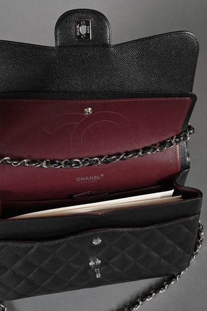 CHANEL. Black quilted caviar leather Timeless...