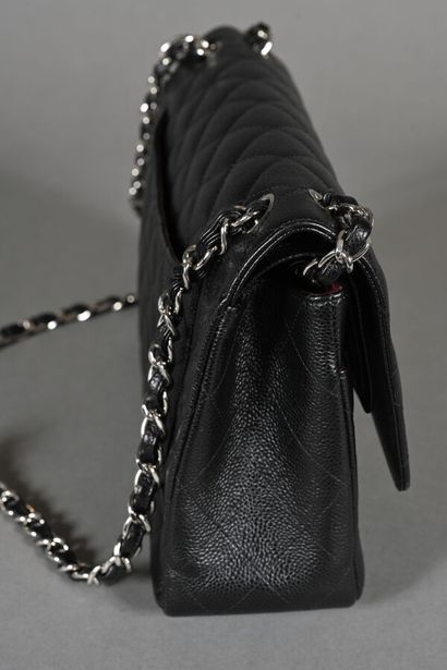 CHANEL. Black quilted caviar leather Timeless...