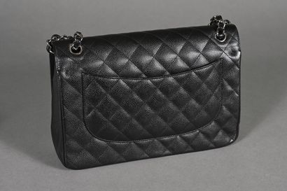 CHANEL. Black quilted caviar leather Timeless...