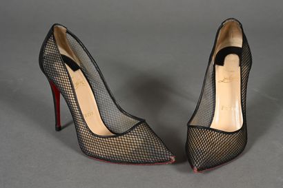 LOUBOUTIN. Pair of black fishnet pumps with...