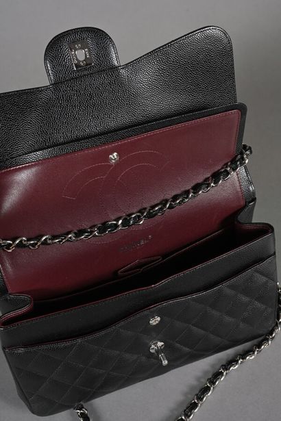 CHANEL. Black quilted caviar leather Timeless...
