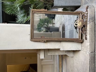 Rectangular mirror in gilded carved wood.
Late...