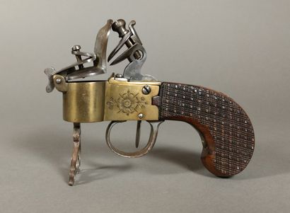 A brass and iron flintlock table lighter...
