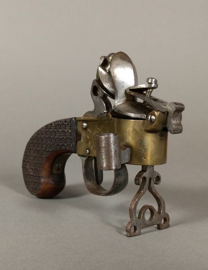 A brass and iron flintlock table lighter...