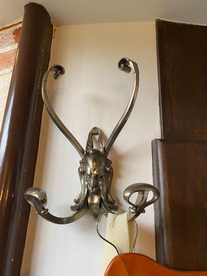 
THREE chrome metal coat hooks decorated...