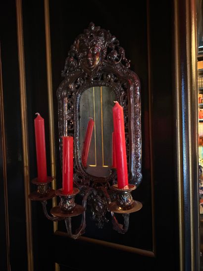A pair of silver plated bronze mirrors with...
