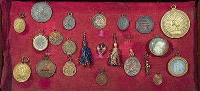 Wall display case containing 20 badges of...
