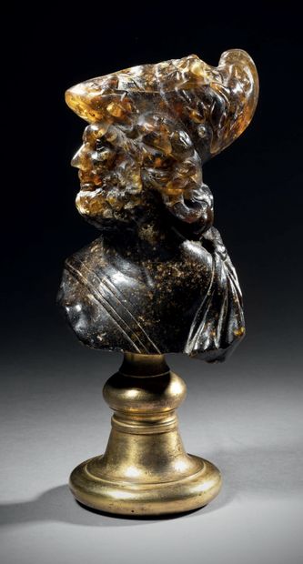Large amber bust carved in the round representing...