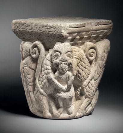 Carved limestone capital historiated on all...