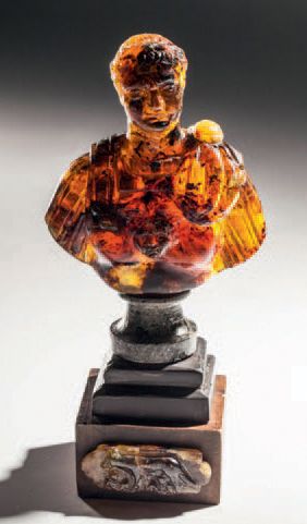 Large amber bust carved in the round representing...