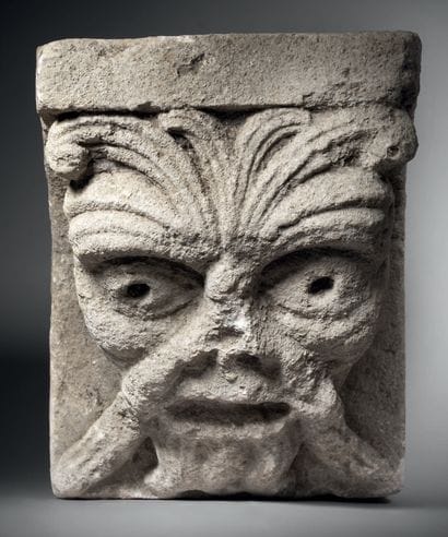 Limestone modillion sculpted in high relief...