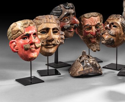 Seven carved wood masks, including five polychrome...