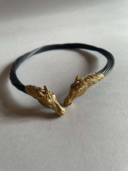 Torque necklace with chased horse heads in...
