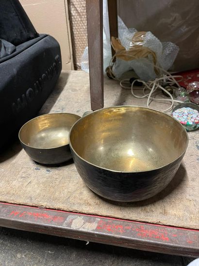 Set of one small and one large brass bowl,...