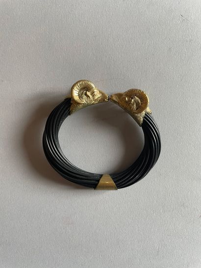 Openwork bangle decorated with chased caprid...