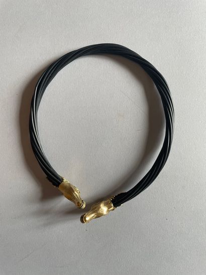 Torque necklace with chased horse heads in...
