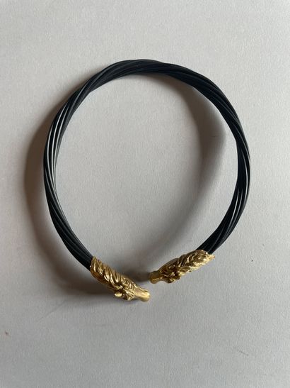 Torque necklace with chased horse heads in...