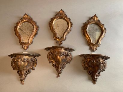 Suite of three carved and gilded wood consoles...