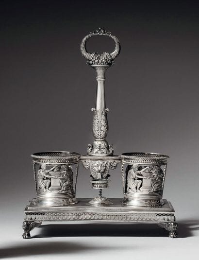 An old man's silver oil and vinegar cruet...