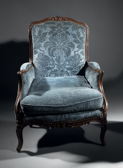 Carved molded beech armchair. Ribbed cambered...