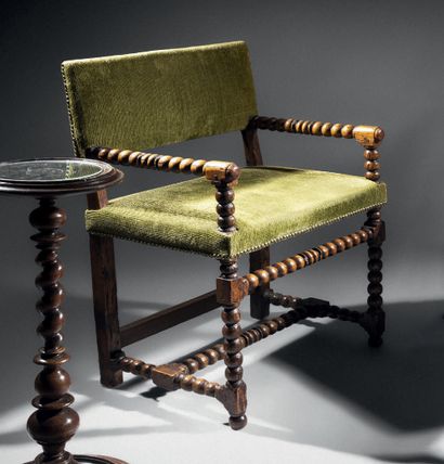 Armchair in natural wood. Ringed front legs...