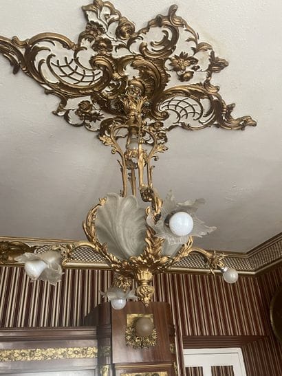 Gilded bronze four-light chandelier. Decorated...