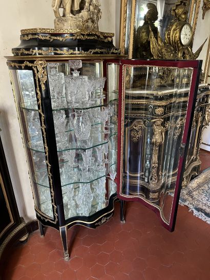 Curved display case in blackened wood with...