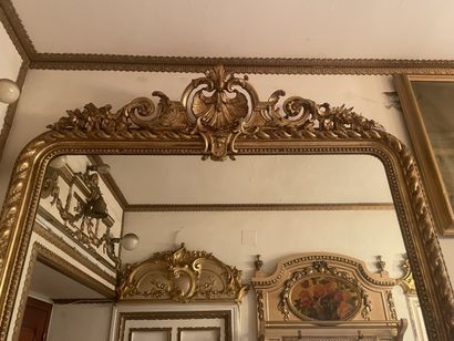 Mirror in stuccoed and gilded wood. Frame...