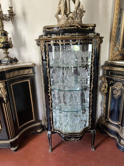 Curved display case in blackened wood with...