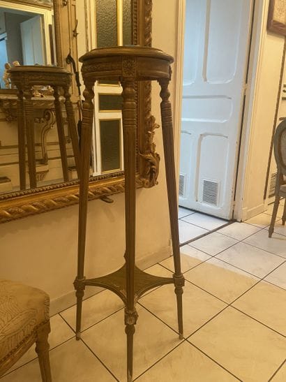 Four-legged pedestal in carved gilded wood....