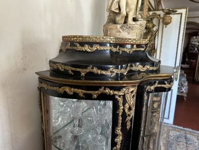 Curved display case in blackened wood with...