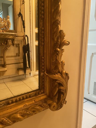 Mirror in stuccoed and gilded wood. Frame...