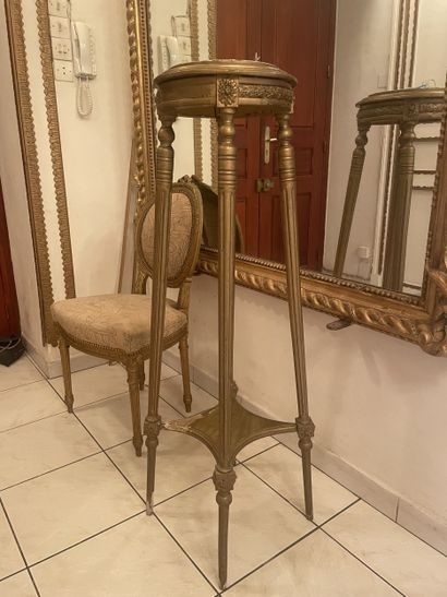 Four-legged pedestal in carved gilded wood....
