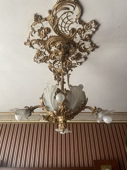 Gilded bronze four-light chandelier. Decorated...