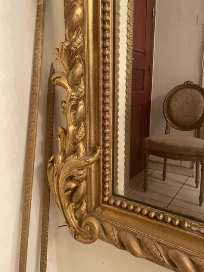 Mirror in stuccoed and gilded wood. Frame...