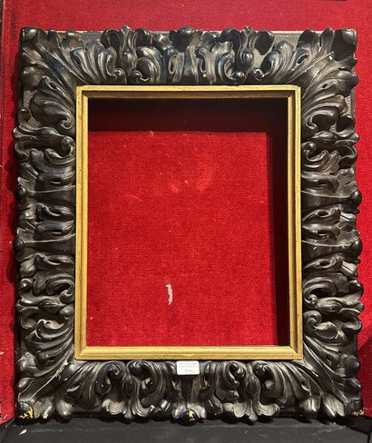 Blackened wood frame with rich acanthus leaf...
