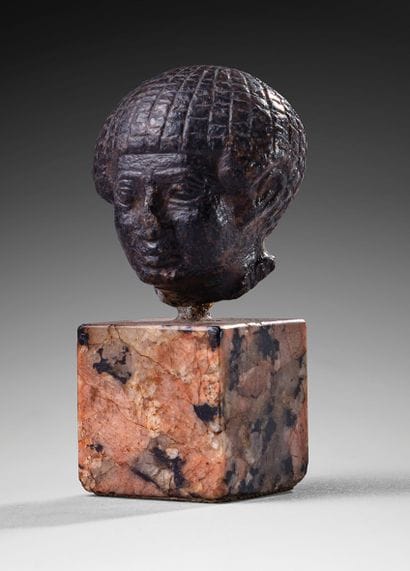 Head depicting a dignitary wearing a multi-row...