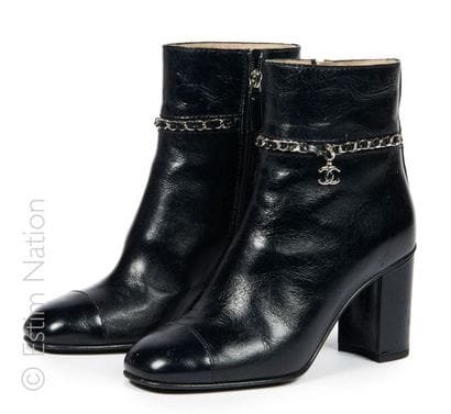 CHANEL
PAIR OF BOOTS in black antique coated...