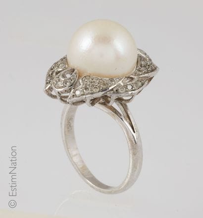 Silver cocktail ring centered with a white...