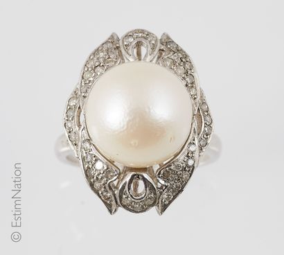 Silver cocktail ring centered with a white...