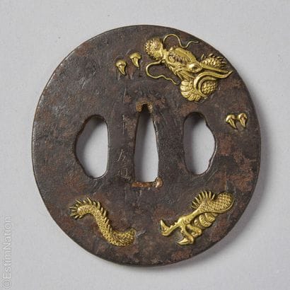 ASIAN ART
Nagamaru gata tsuba in chased iron...