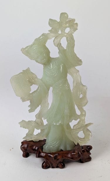 CHINA, 20th century
GUANYN holding a carved...
